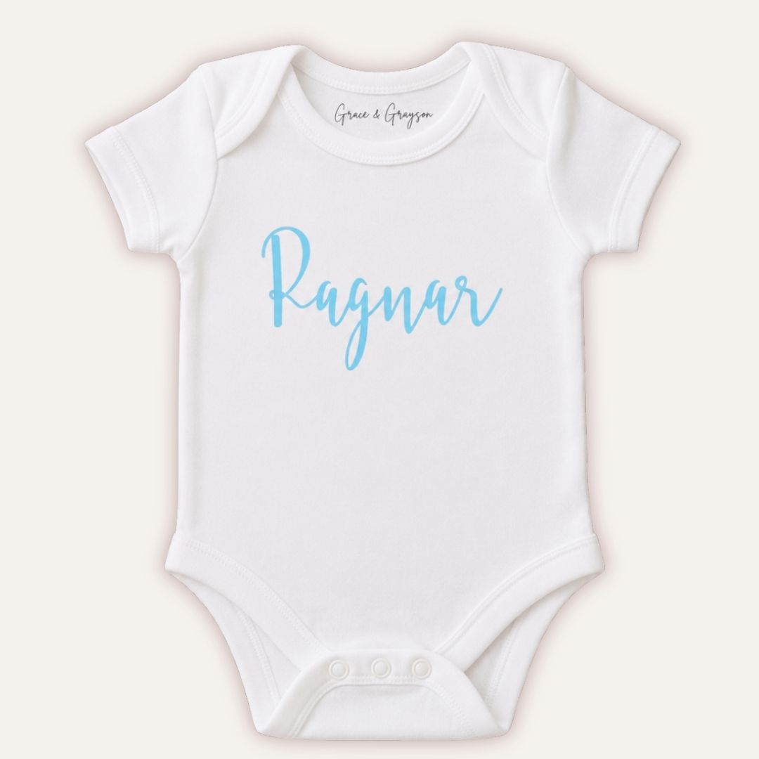 White personalised baby vest with baby blue script lettering, Grace & Grayson.