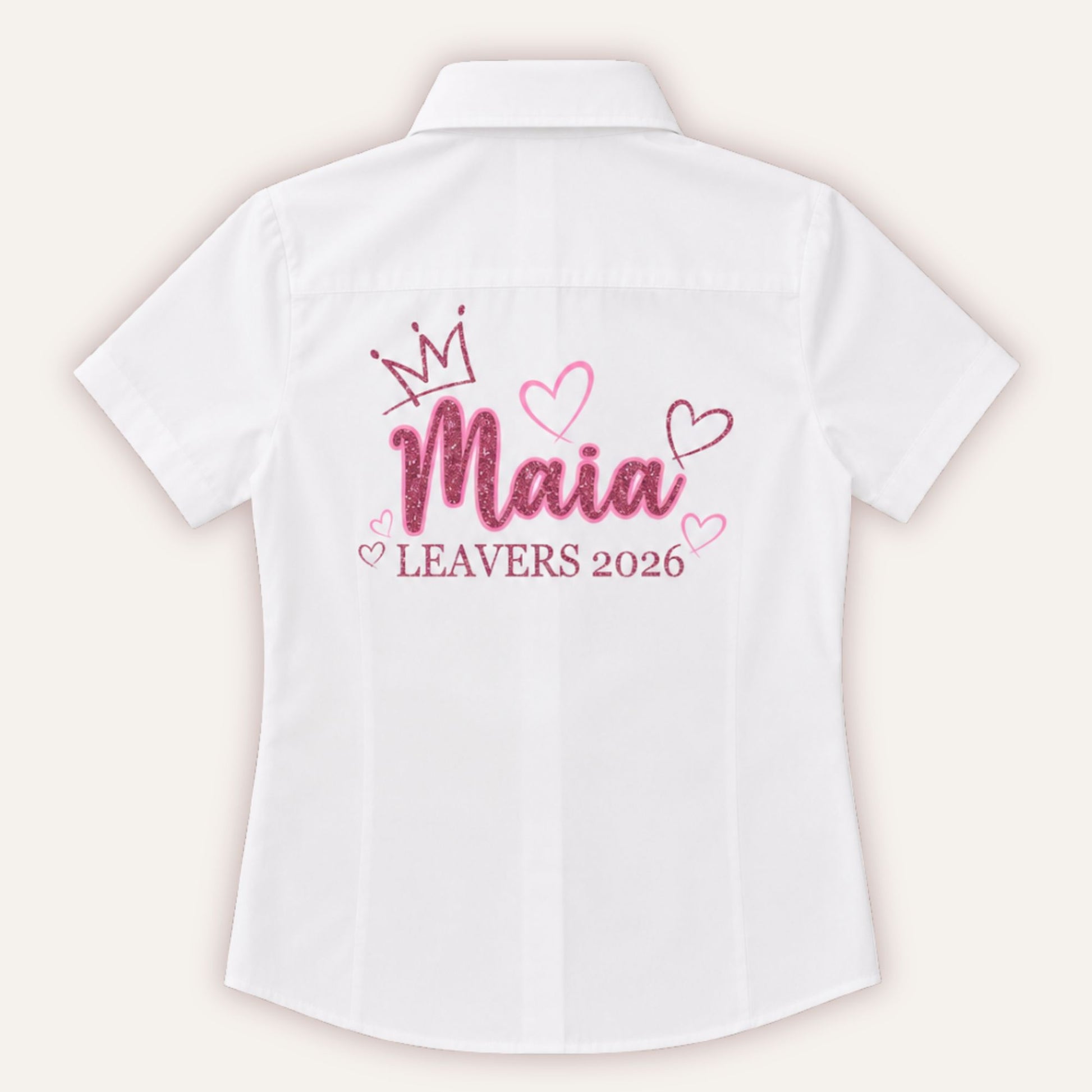 White personalised leavers shirt with glitter crown and hearts design in bubblegum pink and pink glitter, printed with a custom name and Leavers 2026