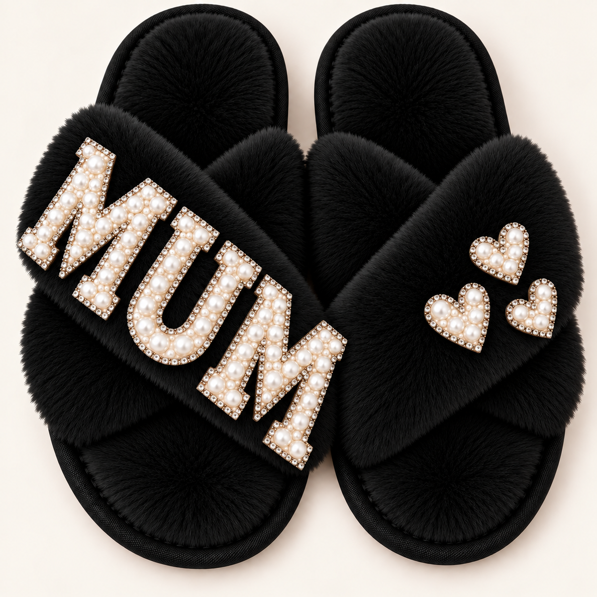  Black faux fur crossover slippers with pearl “MUM” lettering and three pearl hearts, shown on a light background, Grace & Grayson. ⠋