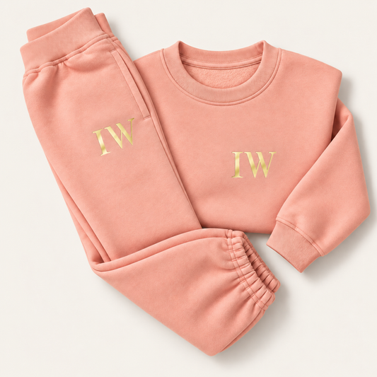 Dusty pink children's sweatshirt and joggers laid flat, personalised with gold initials on the sweatshirt chest and jogger pocket, Grace & Grayson