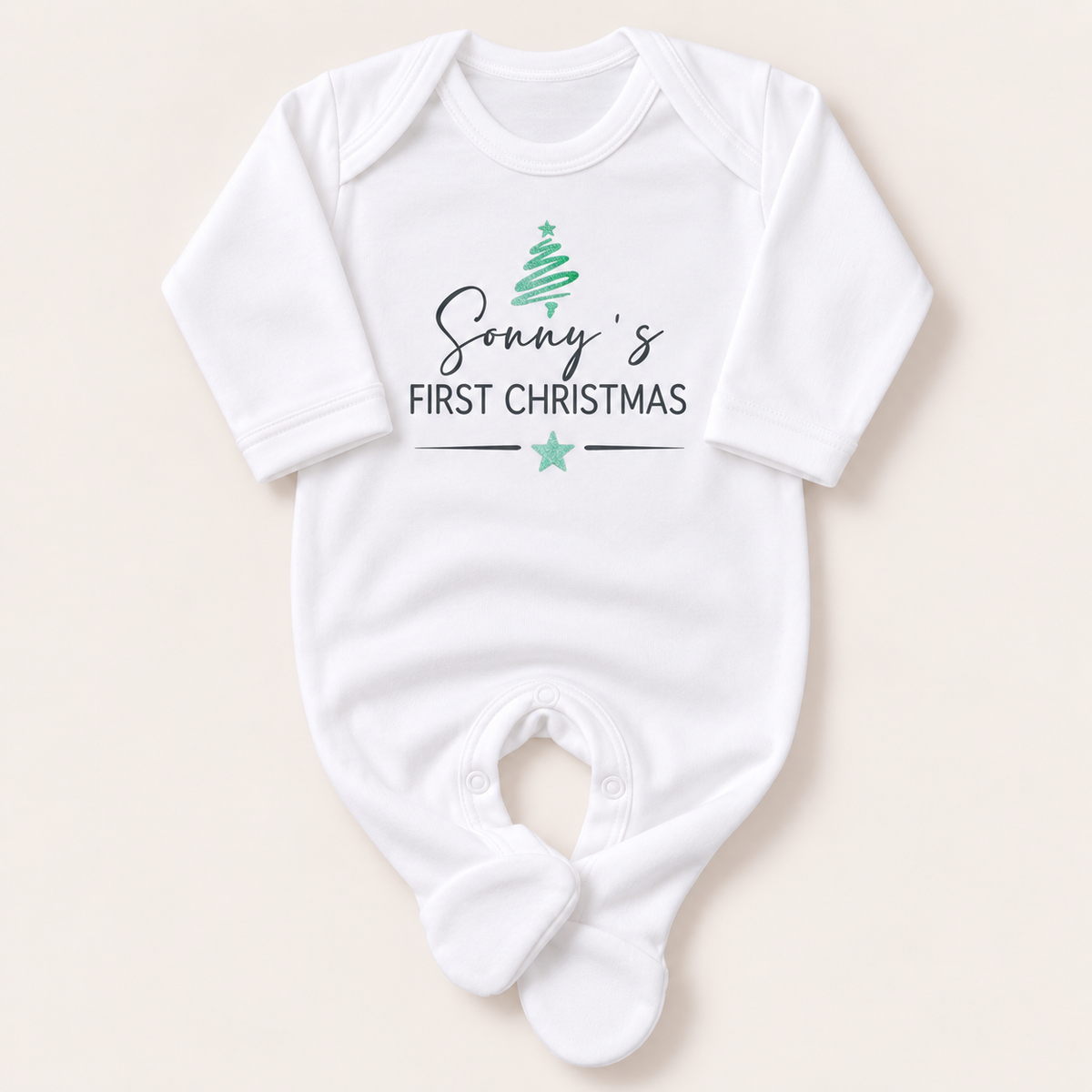 White footed baby grow with a green Christmas tree, grey First Christmas lettering and green star, Grace & Grayson.
