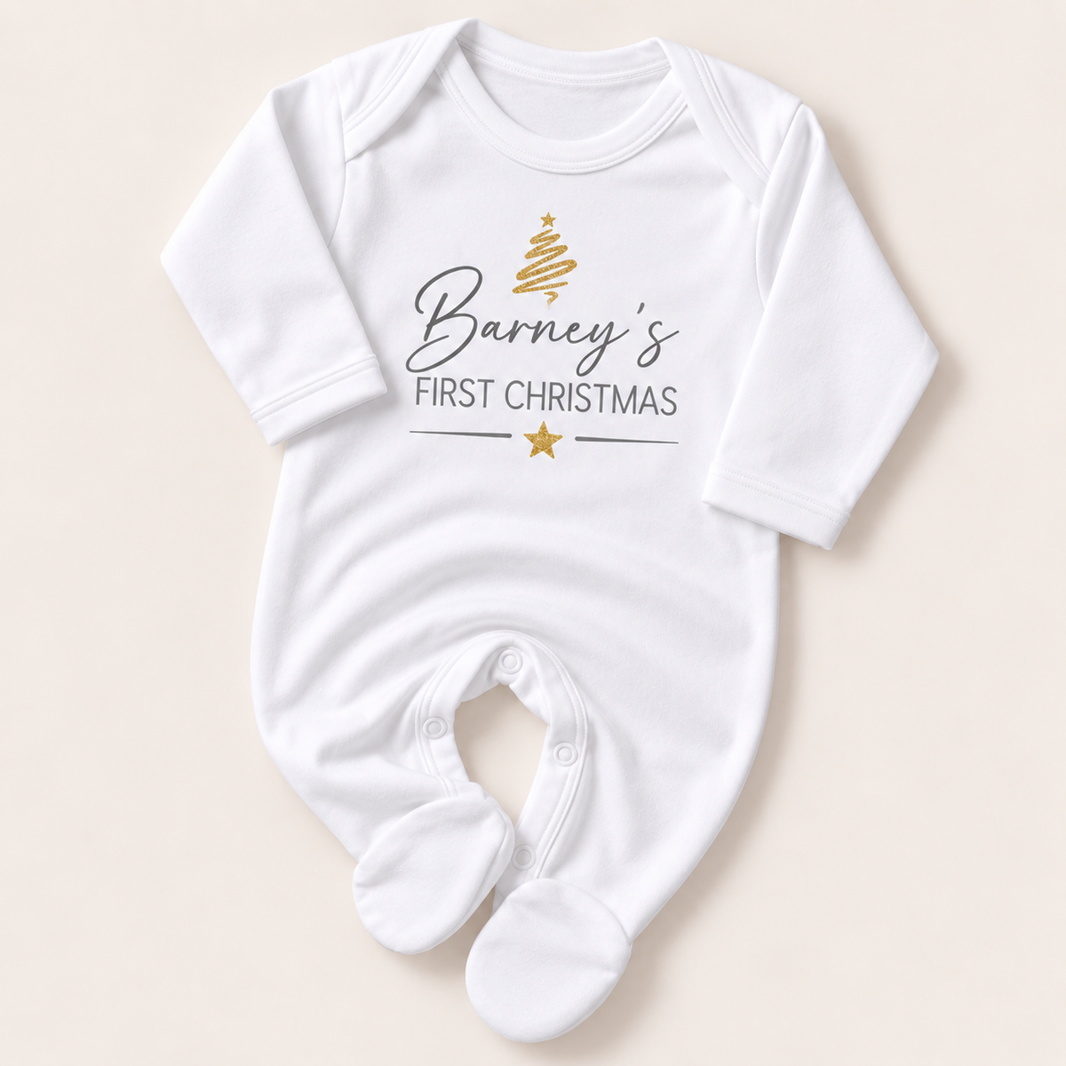 White footed baby grow with a gold Christmas tree, grey First Christmas lettering and gold star, Grace & Grayson.