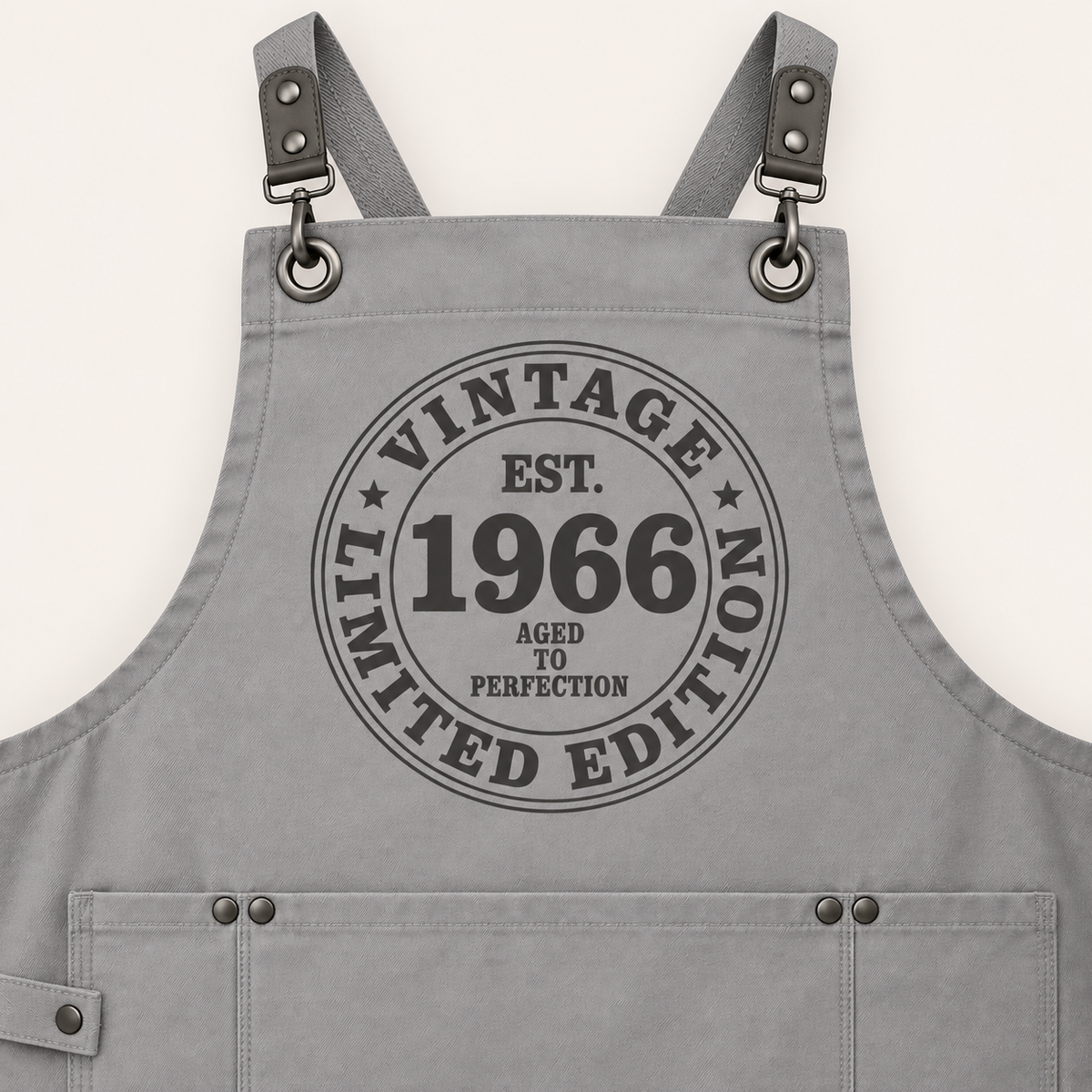 Close-up of grey personalised Vintage Limited Edition apron with a Vintage 1966 year design and front pockets, Grace & Grayson