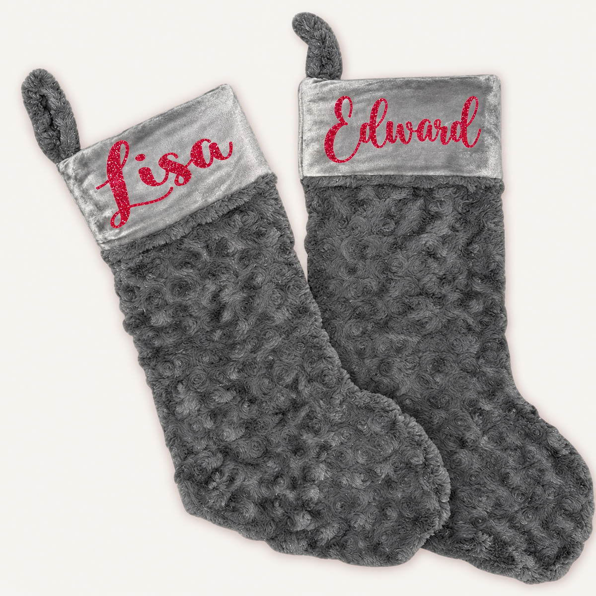 Pair of grey plush Christmas stockings with grey cuffs and red glitter personalised lettering, Grace & Grayson.