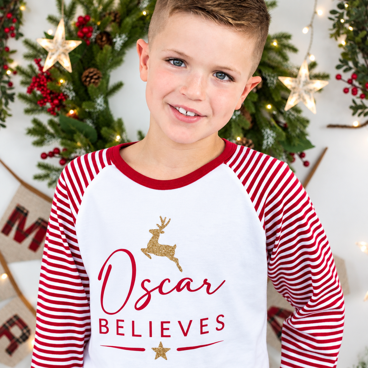 model wearing Red and white striped personalised Believes Christmas pyjamas with a festive design, displayed flat, Grace & Grayson