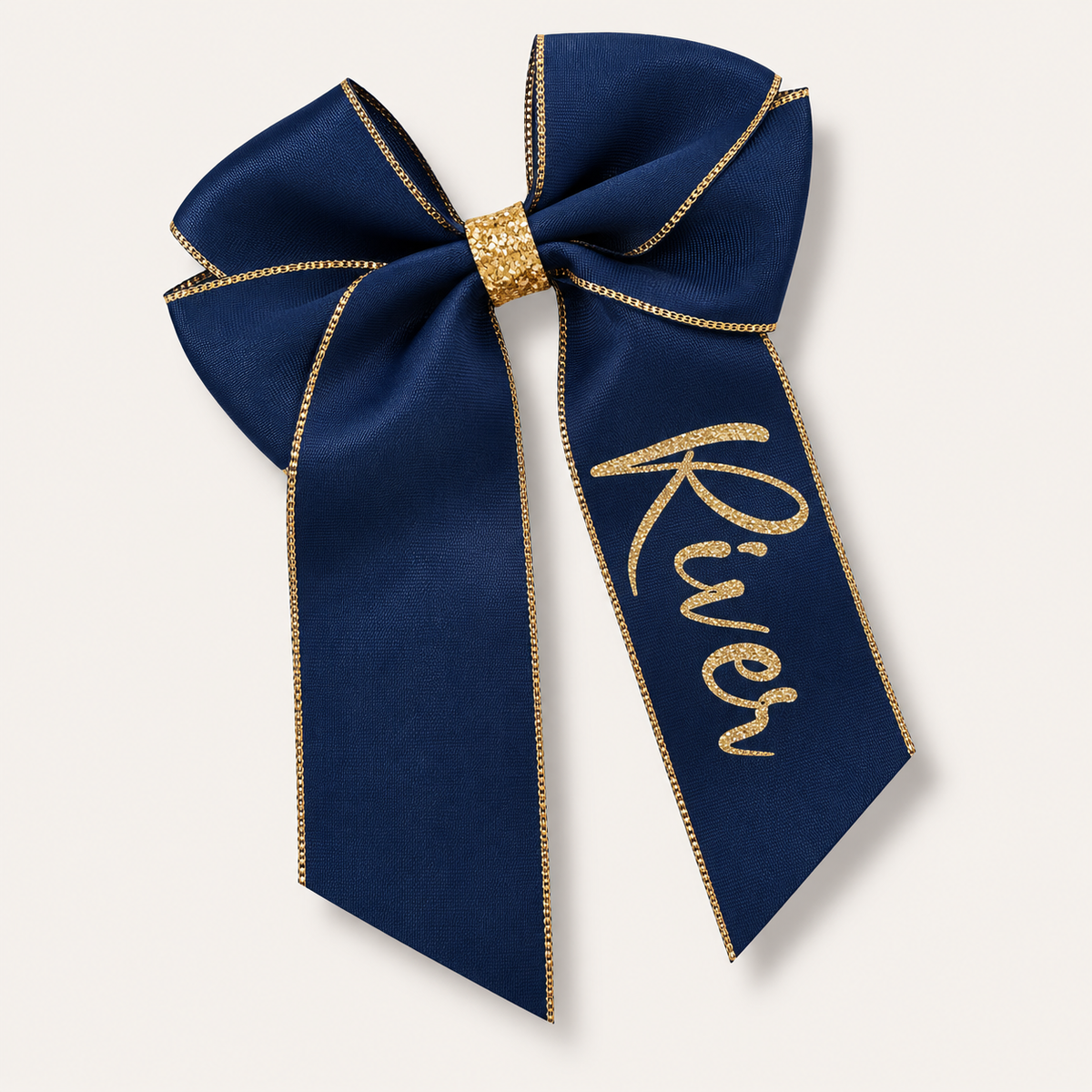 Navy satin hair bow with gold trim, a gold centre wrap and gold glitter lettering, Grace & Grayson.