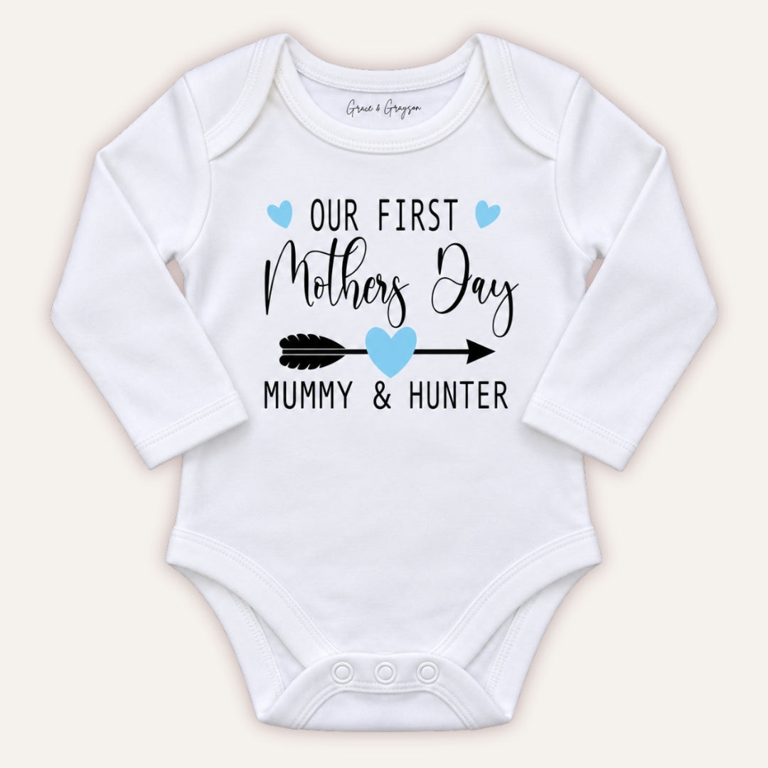 White personalised Our First Mother’s Day baby vest with blue hearts and arrow design, Grace & Grayson