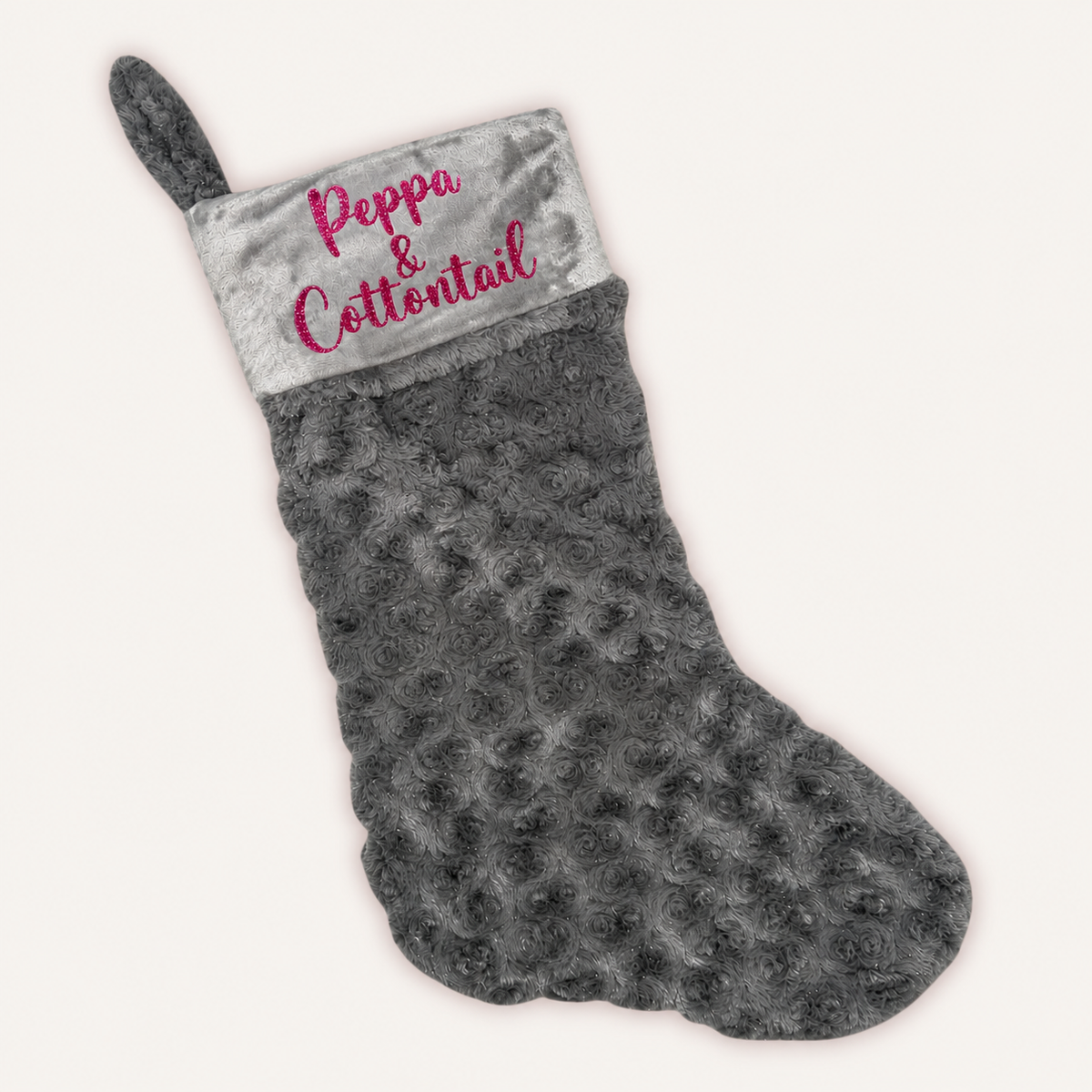 Grey plush Christmas stocking with a grey cuff, pink glitter personalised lettering and a hanging loop, Grace & Grayson.
