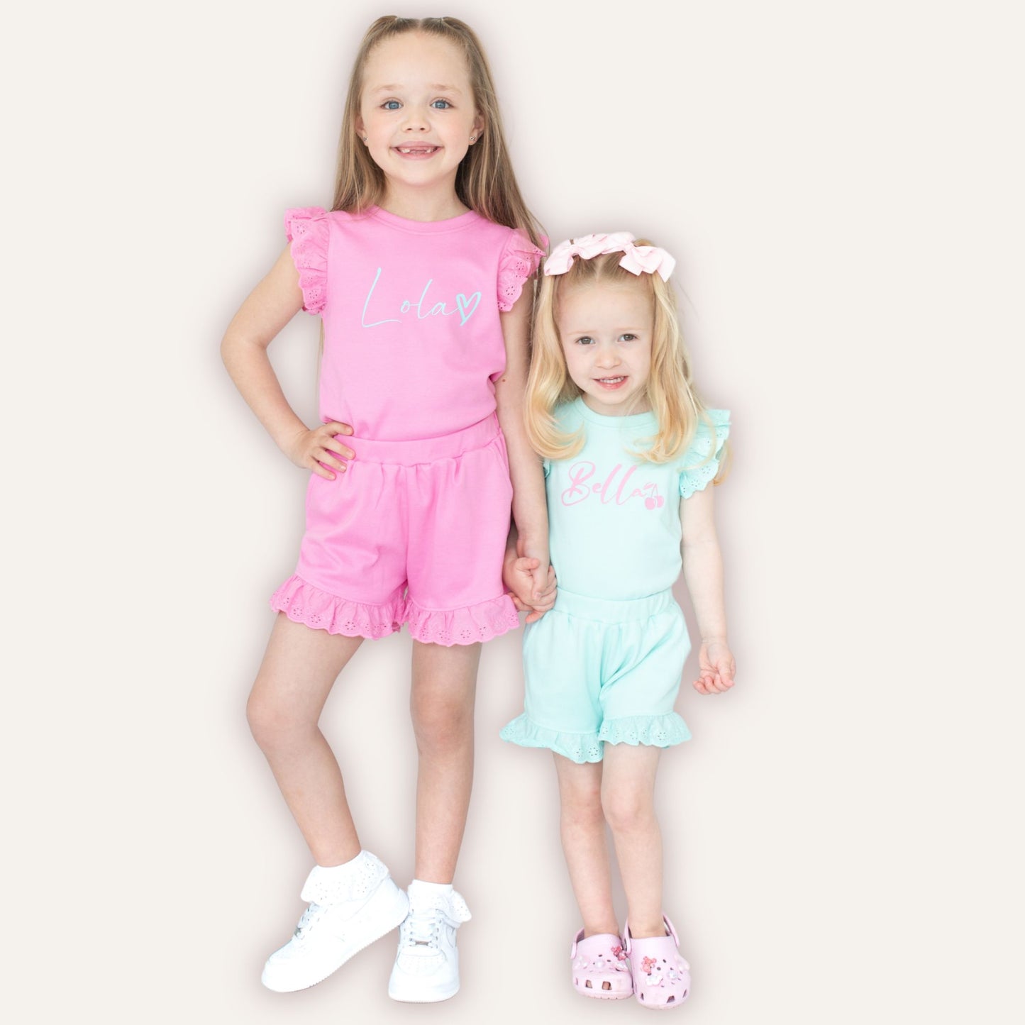 Close-up of personalised heart broderie frill shorts and top set – Grace & Grayson