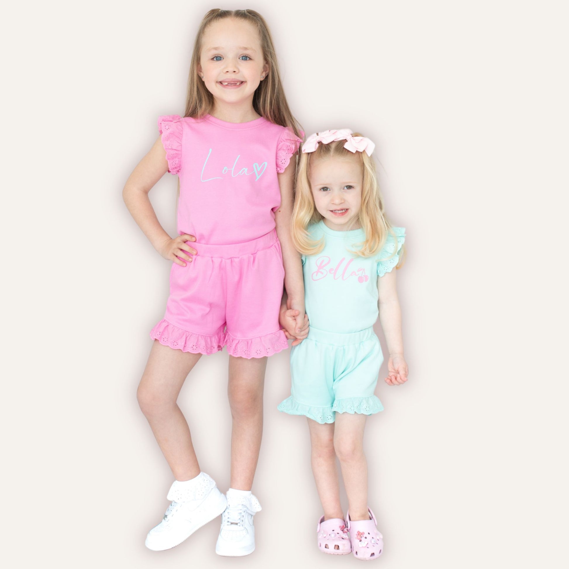 Close-up of personalised heart broderie frill shorts and top set – Grace & Grayson