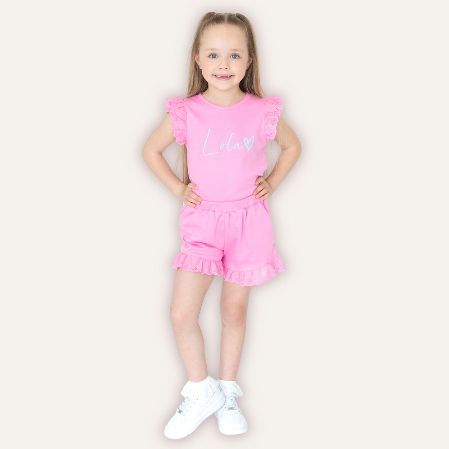 Girl wearing personalised heart broderie frill summer set – Grace & Grayson