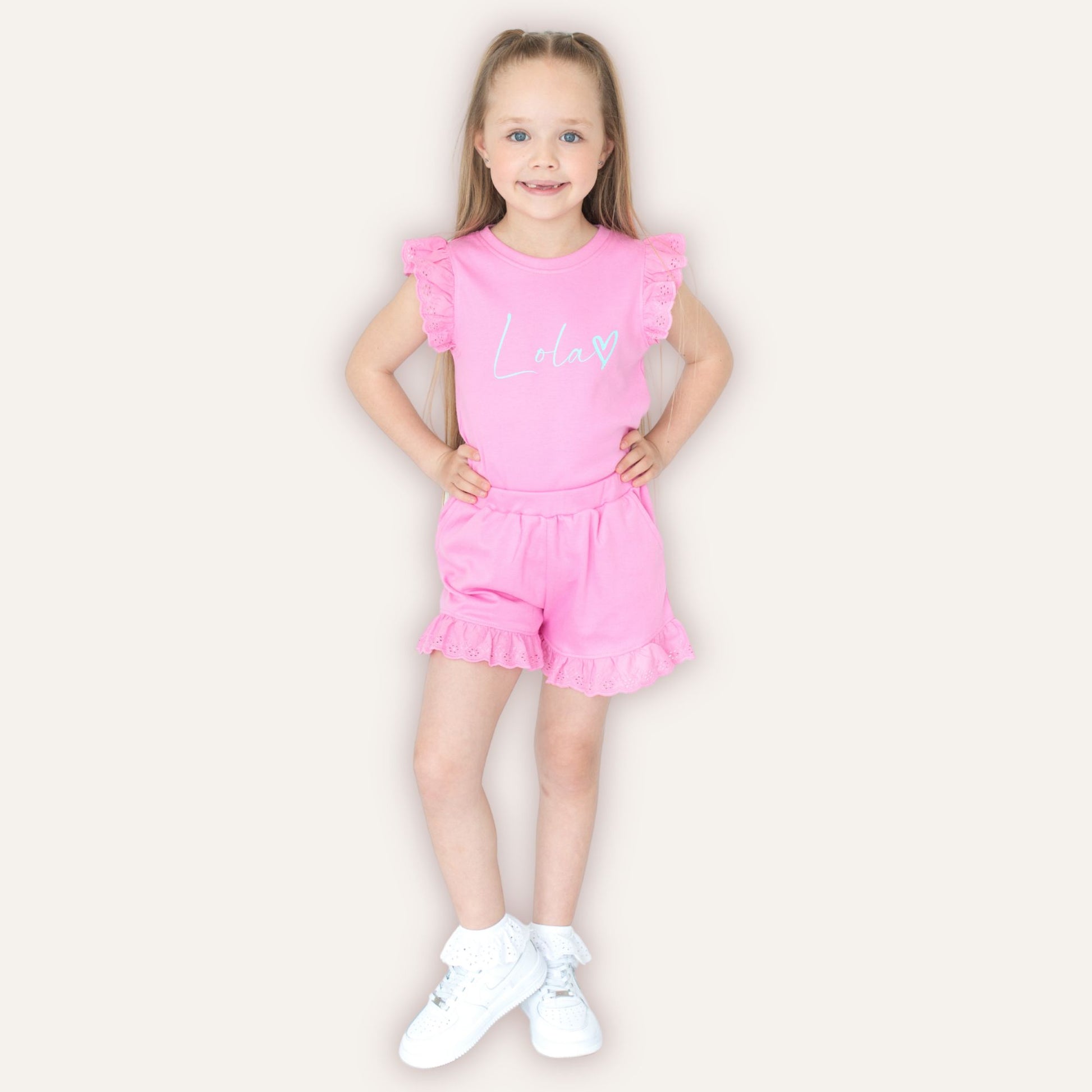 Girl wearing personalised heart broderie frill summer set – Grace & Grayson