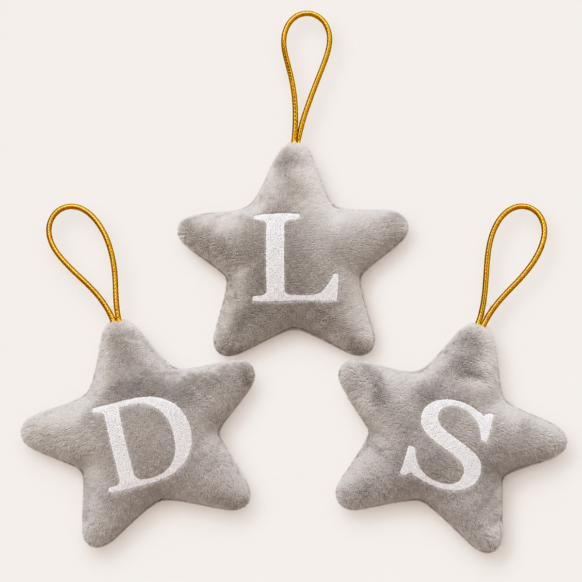 Three grey personalised initial Christmas star tree decorations with white lettering, displayed together, Grace & Grayson