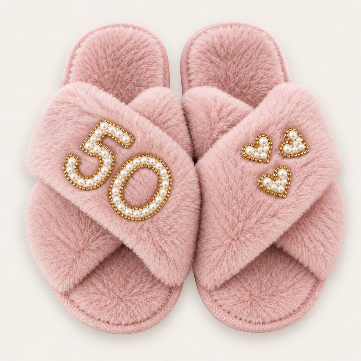 Pink faux fur crossover slippers with a pearl number 50, gold trim and three pearl hearts, Grace & Grayson
