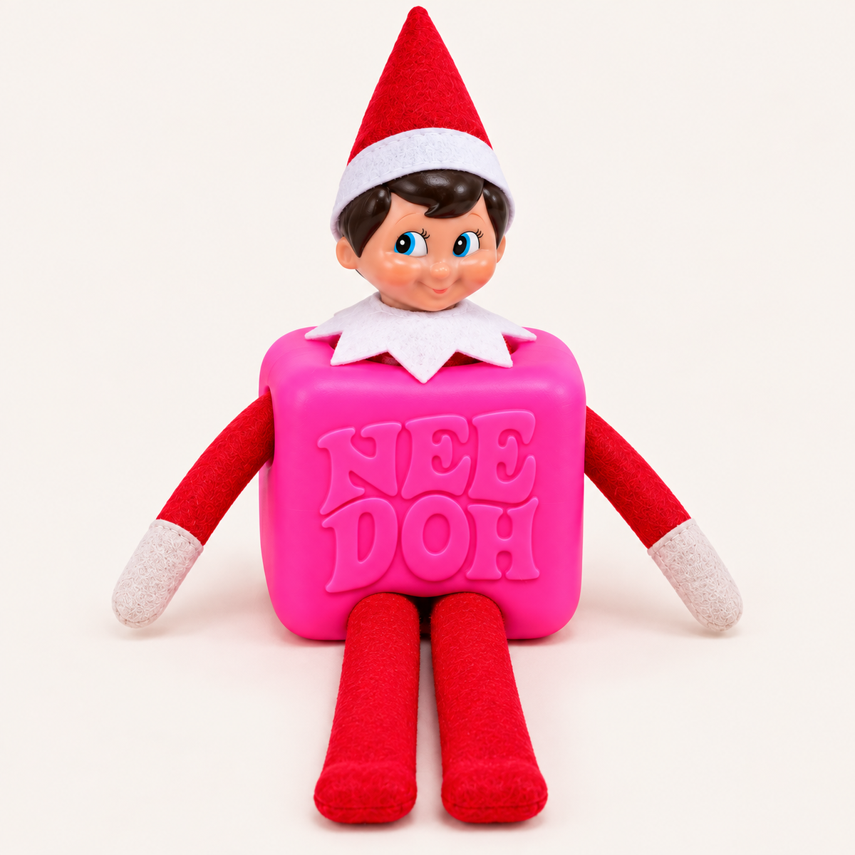 Christmas elf doll wearing a bright pink 3D-printed NeeDoh costume against a light background.
