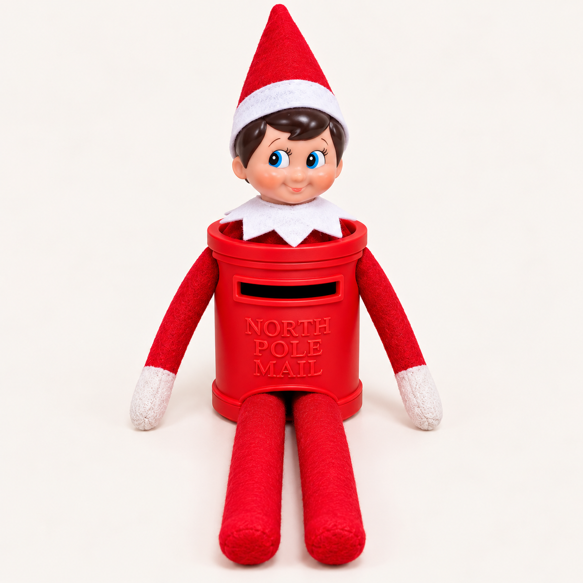 Front-facing Christmas elf on the shelf  in a red North Pole Maill Post Box costume against a light background, Grace and Grayson